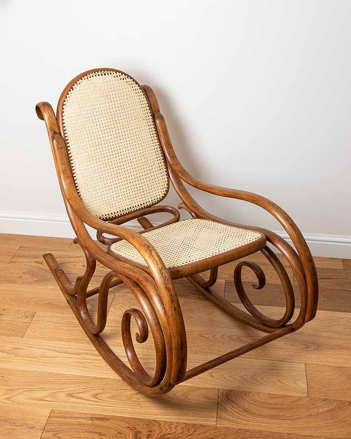 Bent-wood rocking chair with caned seat and back